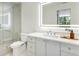 The bathroom shows a glass shower, toilet and vanity with sink, counter, and LED mirror at 2575 Peachtree Ne Rd # 6G, Atlanta, GA 30305