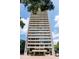 Modern high-rise building with multiple floors and balconies, surrounded by lush greenery at 2575 Peachtree Ne Rd # 6G, Atlanta, GA 30305