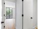 This is a hallway with a view of a bedroom with wood floors and a large window at 2575 Peachtree Ne Rd # 6G, Atlanta, GA 30305
