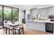 Bright kitchen and dining area with stainless appliances, marble countertops, and large windows at 2575 Peachtree Ne Rd # 6G, Atlanta, GA 30305