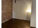 Bedroom with a exposed brick wall, hardwood floors and lamp offers a comfortable and inviting space at 320 Martin Luther King Jr Dr # 5, Atlanta, GA 30312
