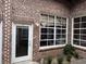Charming exterior featuring a bright door, large windows with blinds, and a touch of greenery for added appeal at 320 Martin Luther King Jr Dr # 5, Atlanta, GA 30312
