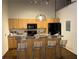A well-equipped kitchen featuring wood cabinets, modern appliances, and a breakfast bar with stylish seating at 320 Martin Luther King Jr Dr # 5, Atlanta, GA 30312