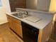 Well-lit kitchen sink offers stainless steel sink, gray countertops and modern dishwasher at 320 Martin Luther King Jr Dr # 5, Atlanta, GA 30312