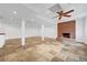 Spacious basement featuring a brick fireplace, tile flooring and recessed lighting at 3243 Northbrook Dr, Atlanta, GA 30341
