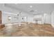 Finished basement with tile floor, recessed lighting, and a set of white kitchen cabinets at 3243 Northbrook Dr, Atlanta, GA 30341
