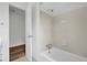 Bright bathroom featuring a tub with tile surround and neutral colored walls at 3243 Northbrook Dr, Atlanta, GA 30341