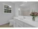Bathroom featuring white cabinets, a large mirror, and a large window offering natural light at 3243 Northbrook Dr, Atlanta, GA 30341