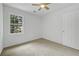 Bedroom featuring carpet, a large window and a white door at 3243 Northbrook Dr, Atlanta, GA 30341