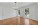 Dining room featuring hardwood floors, decorative trim, windows, and modern lighting at 3243 Northbrook Dr, Atlanta, GA 30341