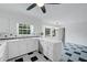 Bright kitchen featuring checkered floors, white cabinetry, stainless steel appliances, and a ceiling fan at 3243 Northbrook Dr, Atlanta, GA 30341