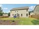 Spacious, grassy backyard featuring a playset, patio, and wood fence, perfect for outdoor living at 4172 Cedar Commons Way, Conley, GA 30288