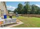 A spacious backyard with patio furniture, grill, playset and wood fence at 4172 Cedar Commons Way, Conley, GA 30288