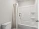 Well-lit bathroom featuring a tub with shower and white fixtures at 4172 Cedar Commons Way, Conley, GA 30288