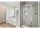 Bathroom with garden tub underneath the window and enclosed glass shower at 4172 Cedar Commons Way, Conley, GA 30288