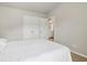 A neutral bedroom featuring carpeted floors, double closets, and a bathroom at 4172 Cedar Commons Way, Conley, GA 30288