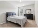Bedroom with a comfortable bed, dresser, and natural light, creating a cozy retreat at 4172 Cedar Commons Way, Conley, GA 30288