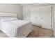 A neutral bedroom featuring carpeted floors, double closets, and a door at 4172 Cedar Commons Way, Conley, GA 30288