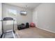 Bright exercise room with mounted television and workout equipment at 4172 Cedar Commons Way, Conley, GA 30288