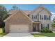 Two-story home with a brick and siding exterior, a two-car garage, and a well-maintained lawn at 4172 Cedar Commons Way, Conley, GA 30288
