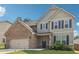 Charming two-story home with a brick and siding exterior, complemented by blue shutters and lush landscaping at 4172 Cedar Commons Way, Conley, GA 30288