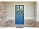 Close-up of a front door with decorative wreath, complemented by brick and siding exterior accents at 4172 Cedar Commons Way, Conley, GA 30288