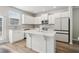 Bright kitchen with white cabinetry, granite countertops, stainless steel appliances, and a central island at 4172 Cedar Commons Way, Conley, GA 30288