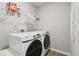 Laundry room showcasing modern washer and dryer, storage shelves, and clean design at 4172 Cedar Commons Way, Conley, GA 30288
