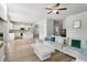 Open-concept living room with hardwood floors, modern sofa, and seamless flow into the kitchen at 4172 Cedar Commons Way, Conley, GA 30288