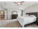 The main bedroom boasts carpet, dark furniture, and an entrance to another room at 4172 Cedar Commons Way, Conley, GA 30288