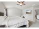 Main bedroom featuring a ceiling fan, tv, neutral walls, carpeted floors, and a bathroom at 4172 Cedar Commons Way, Conley, GA 30288