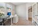 Home office featuring a modern desk setup, natural light, and carpeted floors at 4172 Cedar Commons Way, Conley, GA 30288