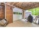 Exposed basement features a white garage door, brick wall, and convenient access to the backyard at 120 Majesty Ln, Fayetteville, GA 30215