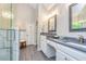 Bathroom with gray countertops, dual sinks, glass-enclosed shower, and wood-look tile flooring at 120 Majesty Ln, Fayetteville, GA 30215