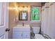Bathroom with vanity, framed mirror, industrial style lighting, and shower with curtain at 120 Majesty Ln, Fayetteville, GA 30215