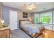 Bedroom with hardwood floors, ceiling fan, natural lighting, and a bay window with bench seating at 120 Majesty Ln, Fayetteville, GA 30215