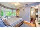 Relaxing bedroom featuring a bay window, ample natural light, and convenient access to additional rooms at 120 Majesty Ln, Fayetteville, GA 30215