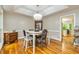 Dining room with tray ceilings, hardwood floors, modern chandelier, and neutral paint at 120 Majesty Ln, Fayetteville, GA 30215