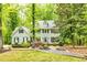 Traditional two-story home with black shutters, mature trees, manicured lawn, and meticulous landscaping at 120 Majesty Ln, Fayetteville, GA 30215