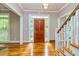 Bright foyer with hardwood floors, decorative ceiling light, and a glimpse of the staircase at 120 Majesty Ln, Fayetteville, GA 30215