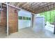 Attached garage with brick accent wall, an outdoor shed, and a concrete driveway at 120 Majesty Ln, Fayetteville, GA 30215