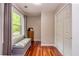 Hallway with hardwood floors, bench seating by the window, and storage closet with double doors at 120 Majesty Ln, Fayetteville, GA 30215