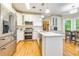 Well-lit kitchen featuring stainless steel appliances, a center island, and white cabinetry at 120 Majesty Ln, Fayetteville, GA 30215