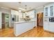 Bright kitchen featuring stainless steel appliances, hardwood floors, white cabinets, and center island at 120 Majesty Ln, Fayetteville, GA 30215