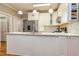 Bright kitchen boasts a marble countertop island, stainless steel appliances, and recessed lighting at 120 Majesty Ln, Fayetteville, GA 30215