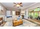 Bright living room with hardwood floors, neutral paint, and access to the sunroom at 120 Majesty Ln, Fayetteville, GA 30215
