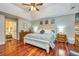 Relaxing main bedroom featuring wood floors, neutral paint, and an ensuite bathroom at 120 Majesty Ln, Fayetteville, GA 30215