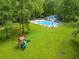 Aerial view of the community pool, playground, and surrounding green space at 120 Majesty Ln, Fayetteville, GA 30215