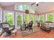 Inviting sunroom with brick floors, ceiling fan, and picturesque backyard views at 120 Majesty Ln, Fayetteville, GA 30215