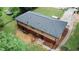 A high-angle view of a two-story house with a well-maintained lawn, red outdoor table, and a newly installed roof at 2468 Dresden Ne Dr, Atlanta, GA 30341